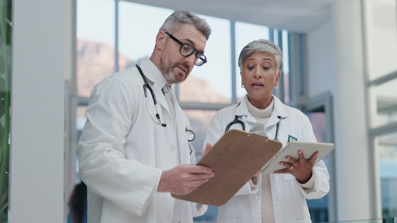 Teamwork, tablet or senior doctors in a discussion