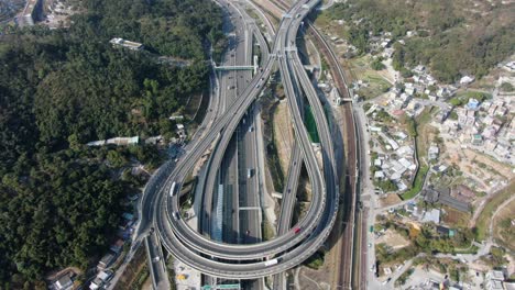 Traffic-on-a-Massive-highway-interchange-with-multiple-levels-and-loop-shaped-road-in-Hong-Kong,-Aerial-view