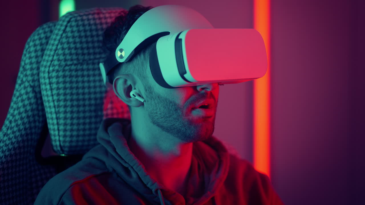 Man watching movie using virtual reality glasses. man makes swiping and touching moves with hands playing VR game. High quality 4k footage