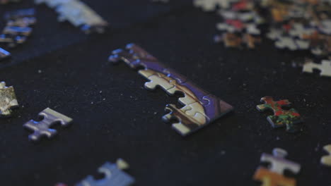 an unsolved puzzle on a large felt mat