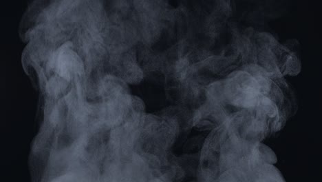 white natural rising steam from food or hot drink isolated on a black background. сan be used in any projects with hot food. slow motion, 4k, 300fps, blackmagic ursa pro g2.