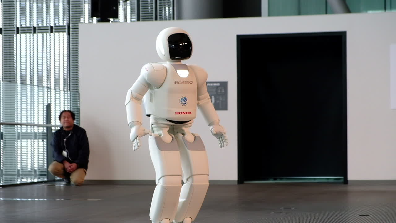 ASIMO Honda robot moving and saluting in Miraikan Museum of Tokyo