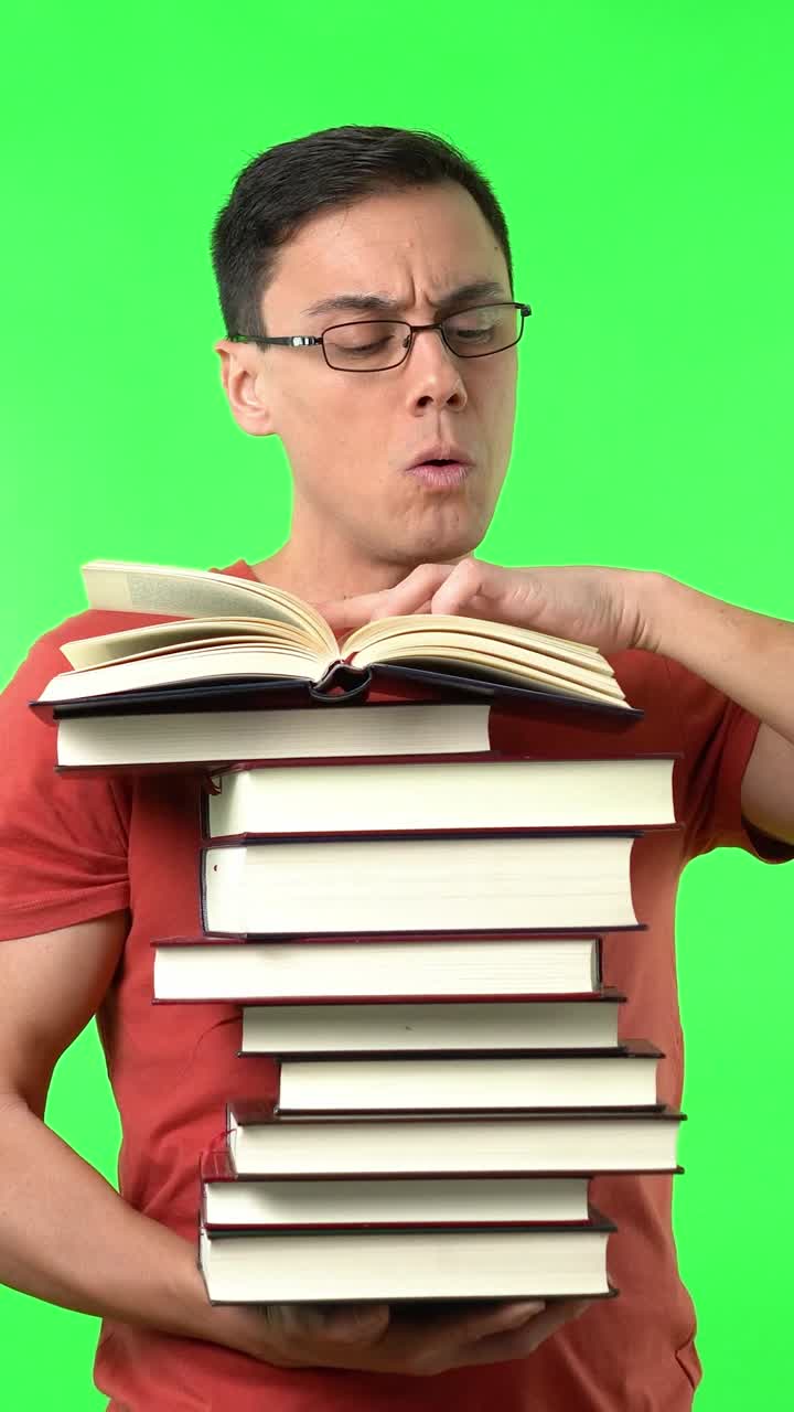 Man reading a stack of books