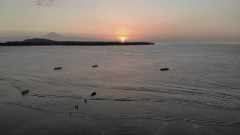 timelapse of beautiful romantic sunset with ducks in swimming in ocean on gili air island,indonesia