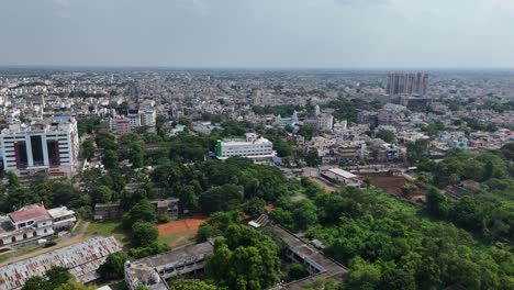 captivating drone shot of vijayawada city, where the busy city streets converge towards a serene hill in the background.