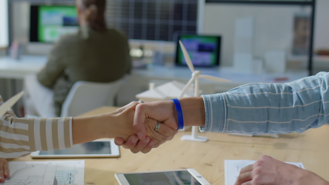 Renewable Energy Engineers Shaking Hands on Office Meeting