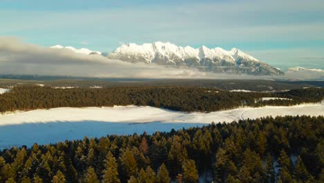 winter's majestic scene: a sunset aerial view of snowcapped mountains and a snowy forest in british columbia