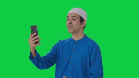 Happy-Muslim-man-talking-on-video-call-Green-screen