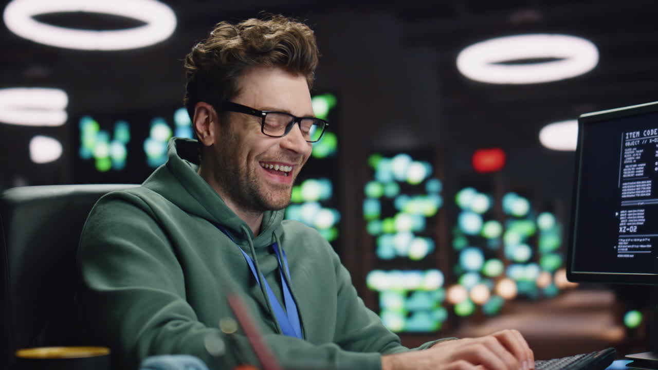 Laughing computer scientist working late datacenter closeup. Man typing keyboard