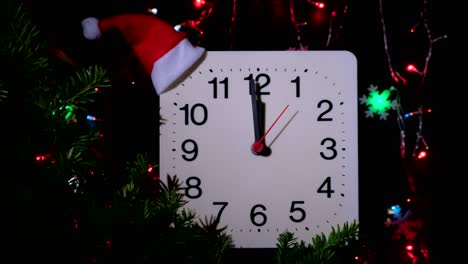 clock in branches of new year's fir on black background. second hand moves in circle of mechanical clock and show twelve o'clock at  midnight and eve of christmas. holiday concept, time lapse, closeup, close-up