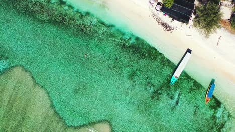 Natural-wave-breaker,-coral-reef-surrounding-the-tropical-island