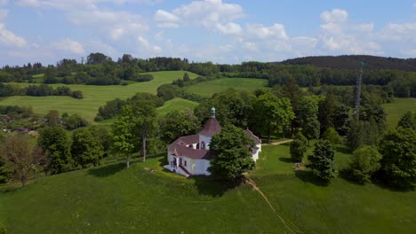 Fantastic-aerial-top-view-flight-Round-Chapel-on-mountain-hill,-Krumlov-Czech-Republic-Summer-2023