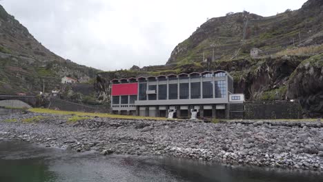 View-of-an-hydroelectric-power-plant-on-the-river-mouth,-Steady-camera-showing-the-water-leaving-the-hydroelectric-plant-back-to-the-river-mouth