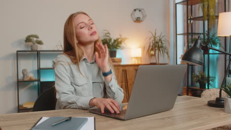 Young woman disinterested boring laptop work lazy thinking boredom working burnout at table at home