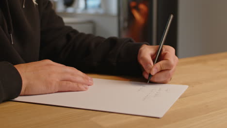 caucasian man writing with left hand