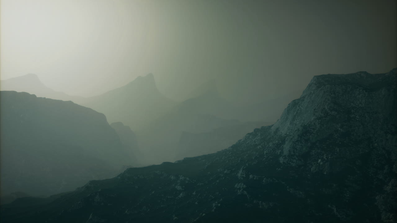 Foggy mountains create a mysterious landscape in early morning light