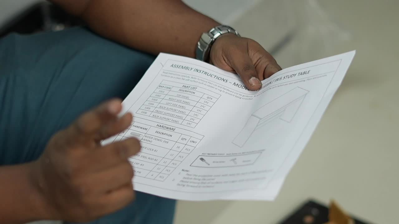 Man showing manual paper of a wooden table closeup shot