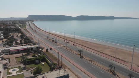 Aerial-shot-of-car-running-in-the-street-of-gawadar-balochistan-near-the-beach