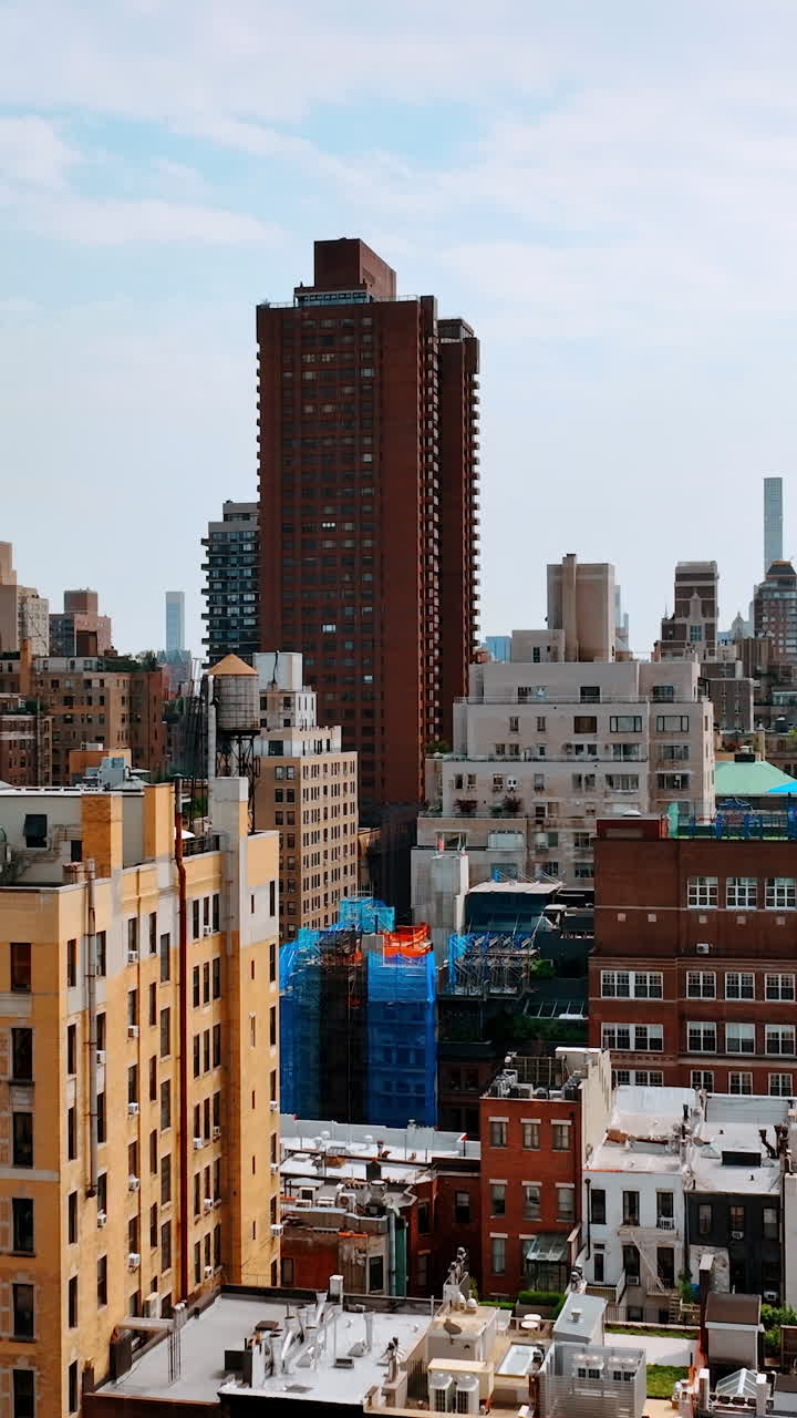 Residential area buildings of diverse size and design. Drone footage descending above the scenery of New York. Vertical video