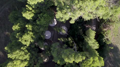 tipi tent campground seen from above at a countryside estate in montpelier france, aerial rotating shot