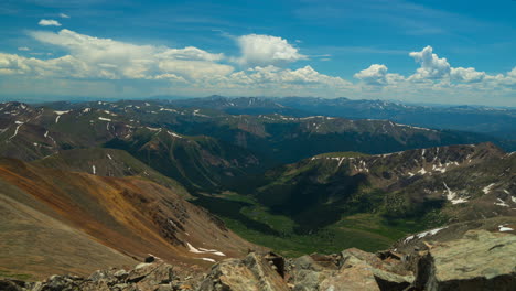 cinematic time lapse top of the world grays and torreys 14er rocky mountains peaks layers colorado breckenridge landscape in background sunny summer day peaceful blue sky clouds rolling snow at top