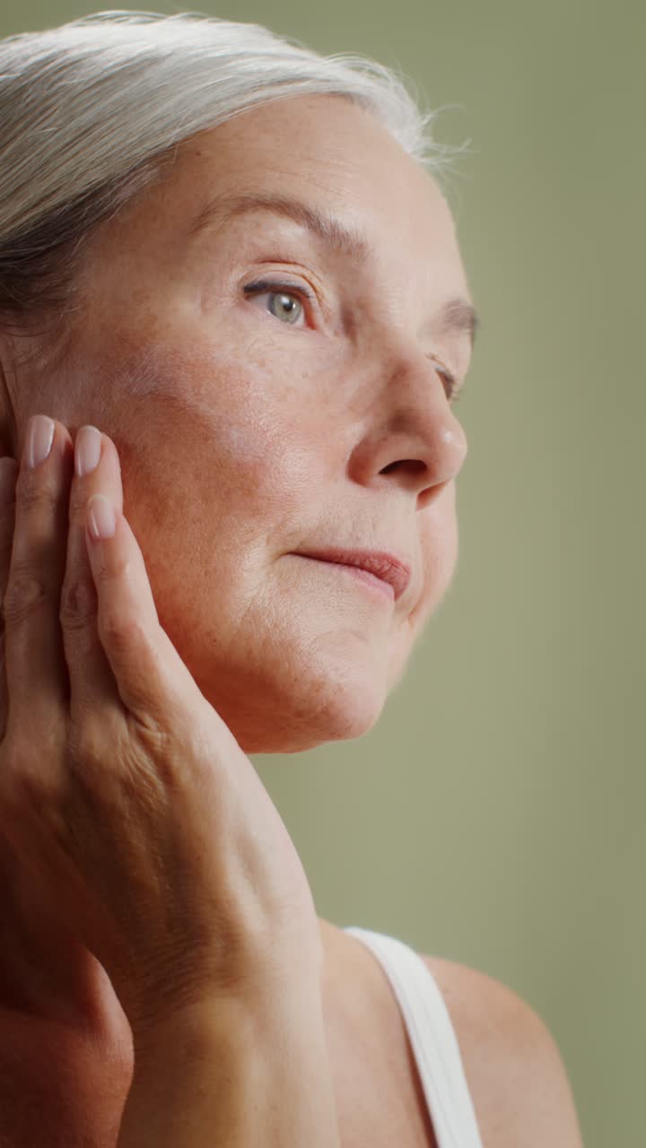 Mature Woman Applying Skincare Product