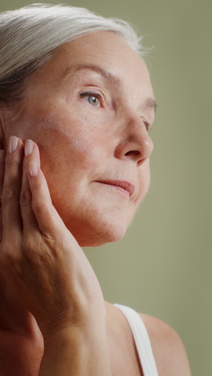 Mature Woman Applying Skincare Product