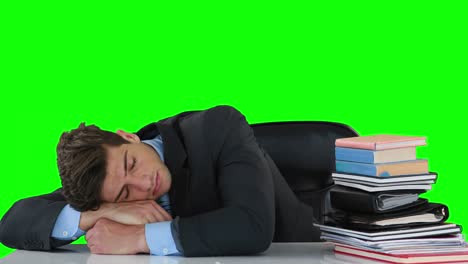 Exhausted-businessman-sleeping-on-the-desk