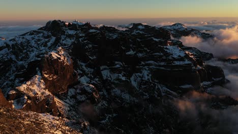 Drone-shot-over-a-valley-up-in-the-mountains-of-Madeira-with-snow