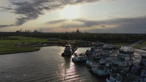 Point-of-view-flight-around-docked-push-boats-near-Bridge-City,-Texas