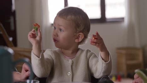 Caucasian-baby-eating-strawberries-at-home