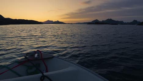 boat trip with a small boat towards the islands on a bright and calm summer night. lofoten, northern norway