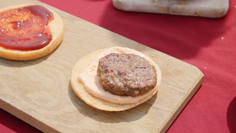 a extra burger being placed on top of a other burger