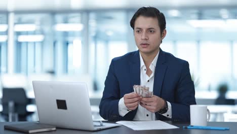 upset indian businessman counting money