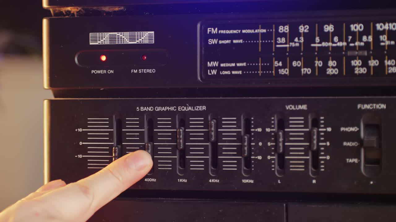 Retro fm am radio tape, music, technology, people and equipment concept - man using mixing console in sound recording studio