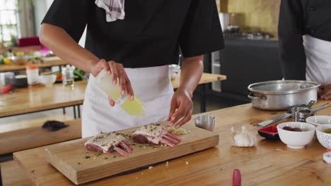 Diverse-group-of-chefs-preparing-dishes-and-smiling