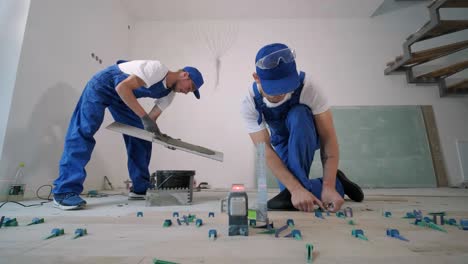 installing ceramic floor tiles - measuring and cutting the pieces. construction, renovation, repair apartment. cuts tile. tile cutting