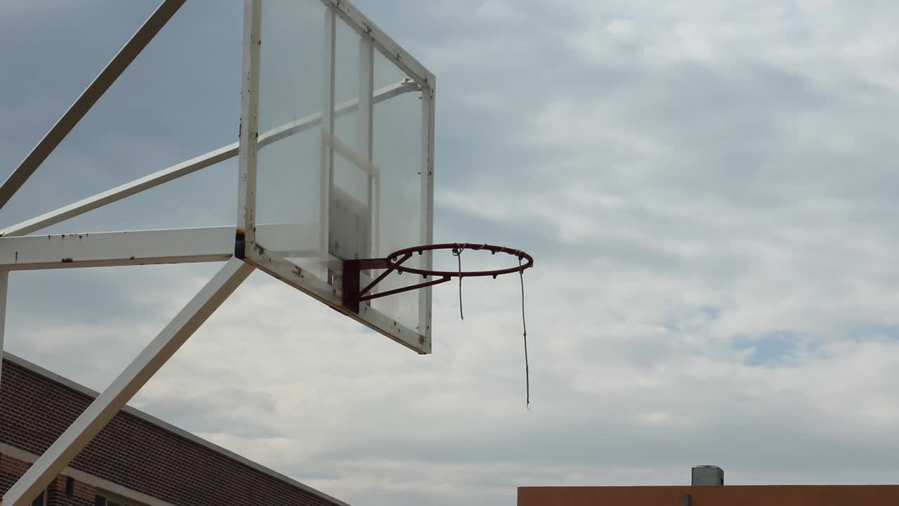 un ring de baloncesto en una escuela en asia con fondo nublado de lapso de tiempo