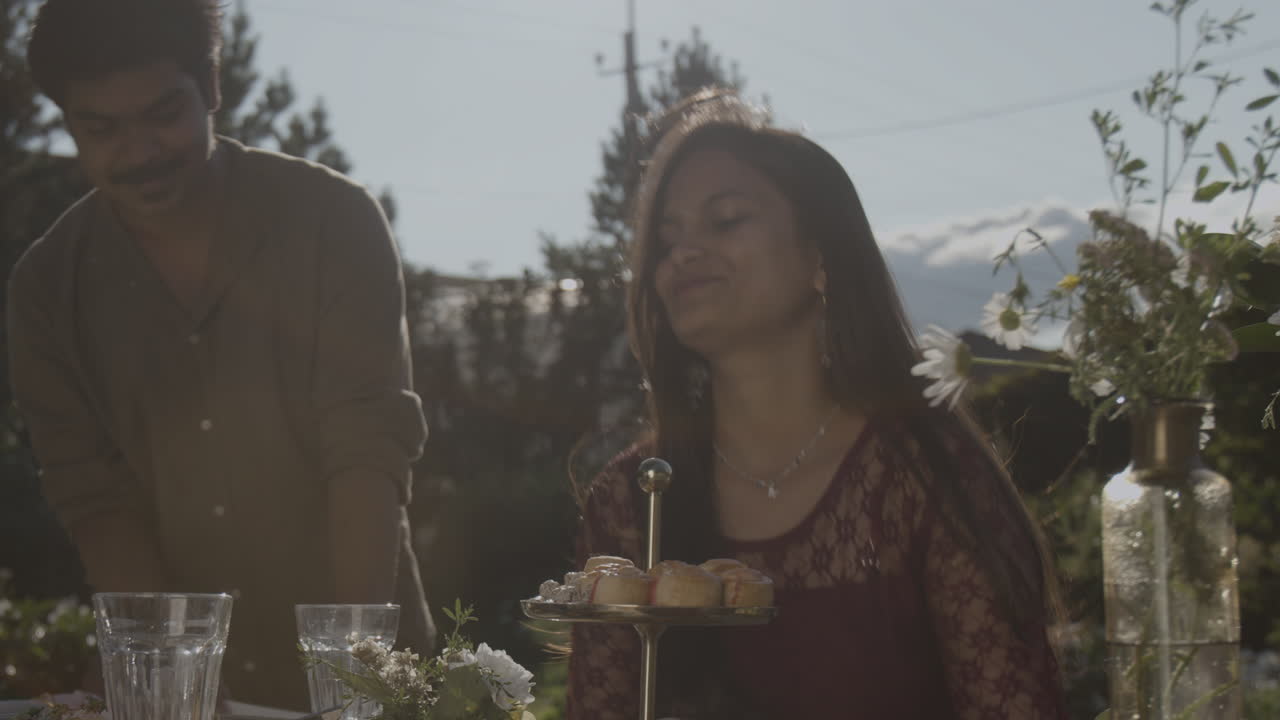 Couple enjoys an outdoor garden party with desserts