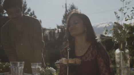 couple enjoys an outdoor garden party with desserts