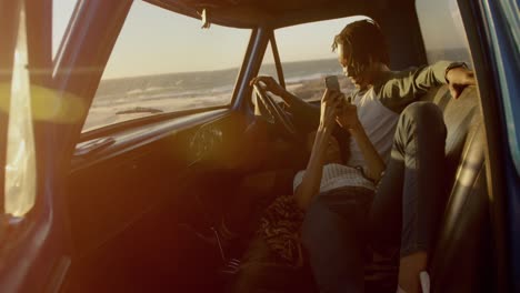 woman lying on mans lap in a pickup truck at beach 4k