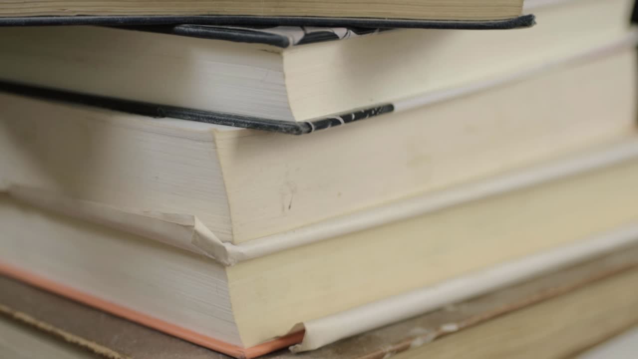 Books stacked in a pile tilting shot