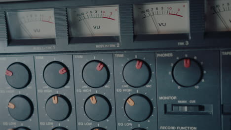 male hand using vintage multitrack cassette recorder for making music