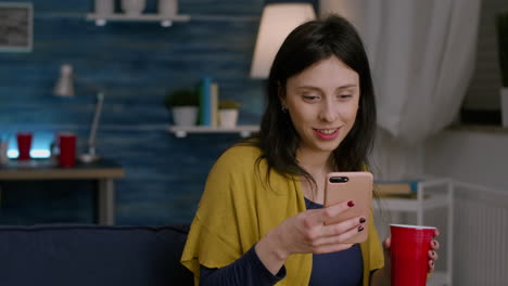 beautiful woman holding phone in hand reading message on internet