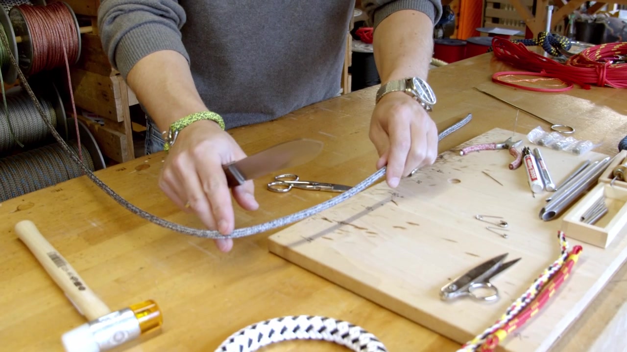 Craftsman measuring silver color string to make new bracelet, workshop interior shot