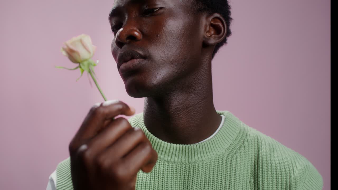 Portrait of a man holding a rose