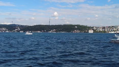 a beautiful view of the sea with a boat and a city in the background