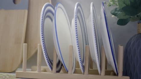 stack of dishes on a wooden drying rack