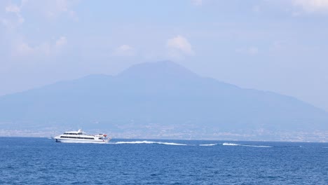 a ship cruises past mount vesuvius in naples