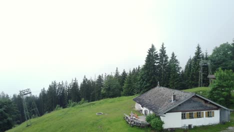 small and lonely lodge in the austrian alps on a cloudy day